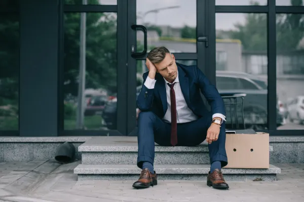 dismissed-businessman-in-suit-sitting-on-stairs-ne-2026-03-12-23-51-09-utc1-69ce5954bfded
