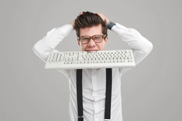 stressed-programmer-with-keyboard-in-mouth-2026-03-25-00-06-48-utc-69ce687e92224